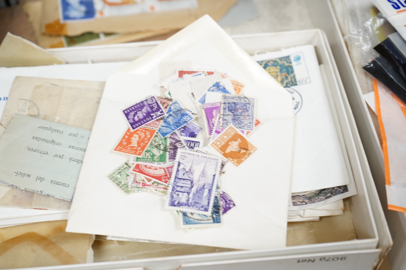 A collection of sundry items to include a scrapbook and a large collection of various stamps